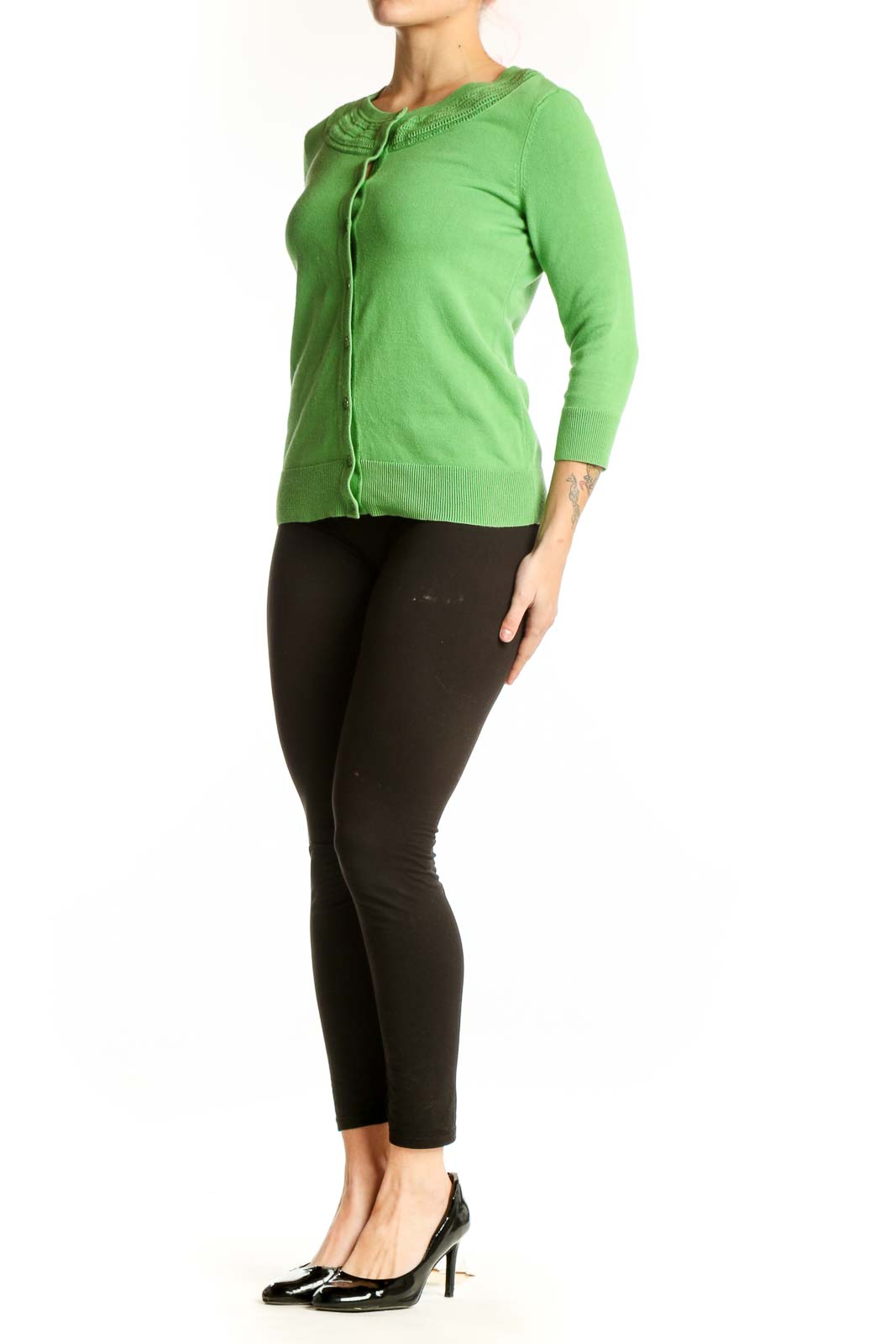 Green button-front cardigan with crew neckline and ribbed detailing, worn with black pants