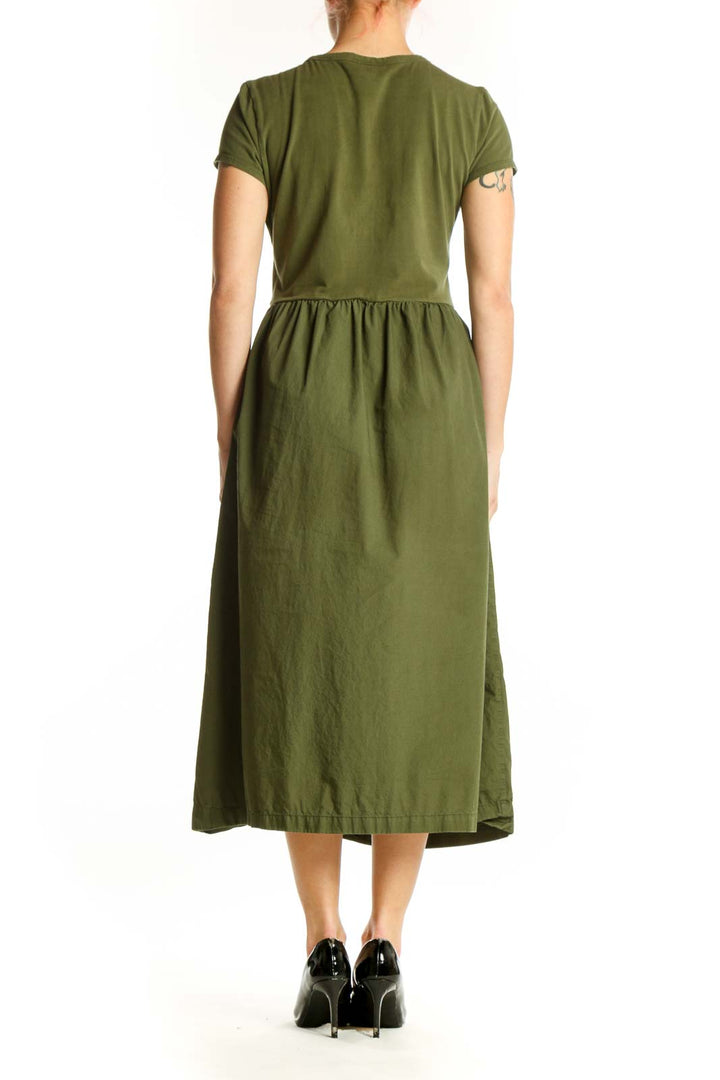 Back view of olive green cotton midi dress showing flowing A-line skirt