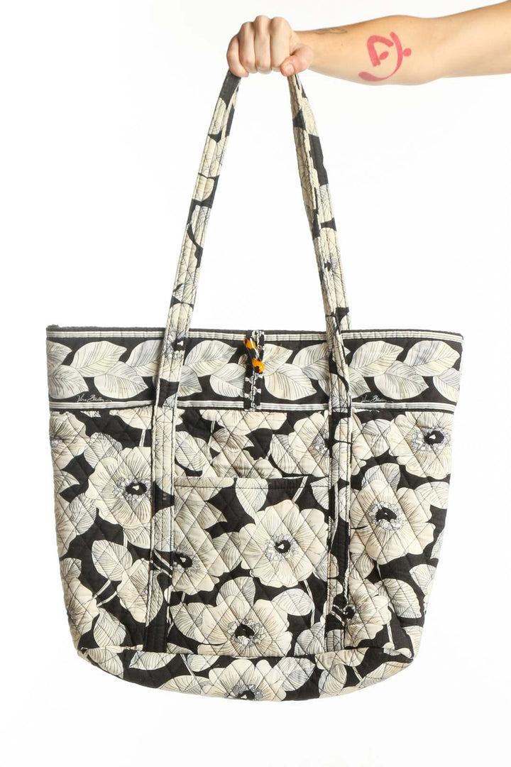 Black and cream floral quilted Vera Bradley tote bag with dual handles, front view