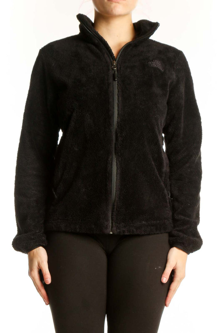Black fleece zip-up jacket by The North Face with high collar, front view on model