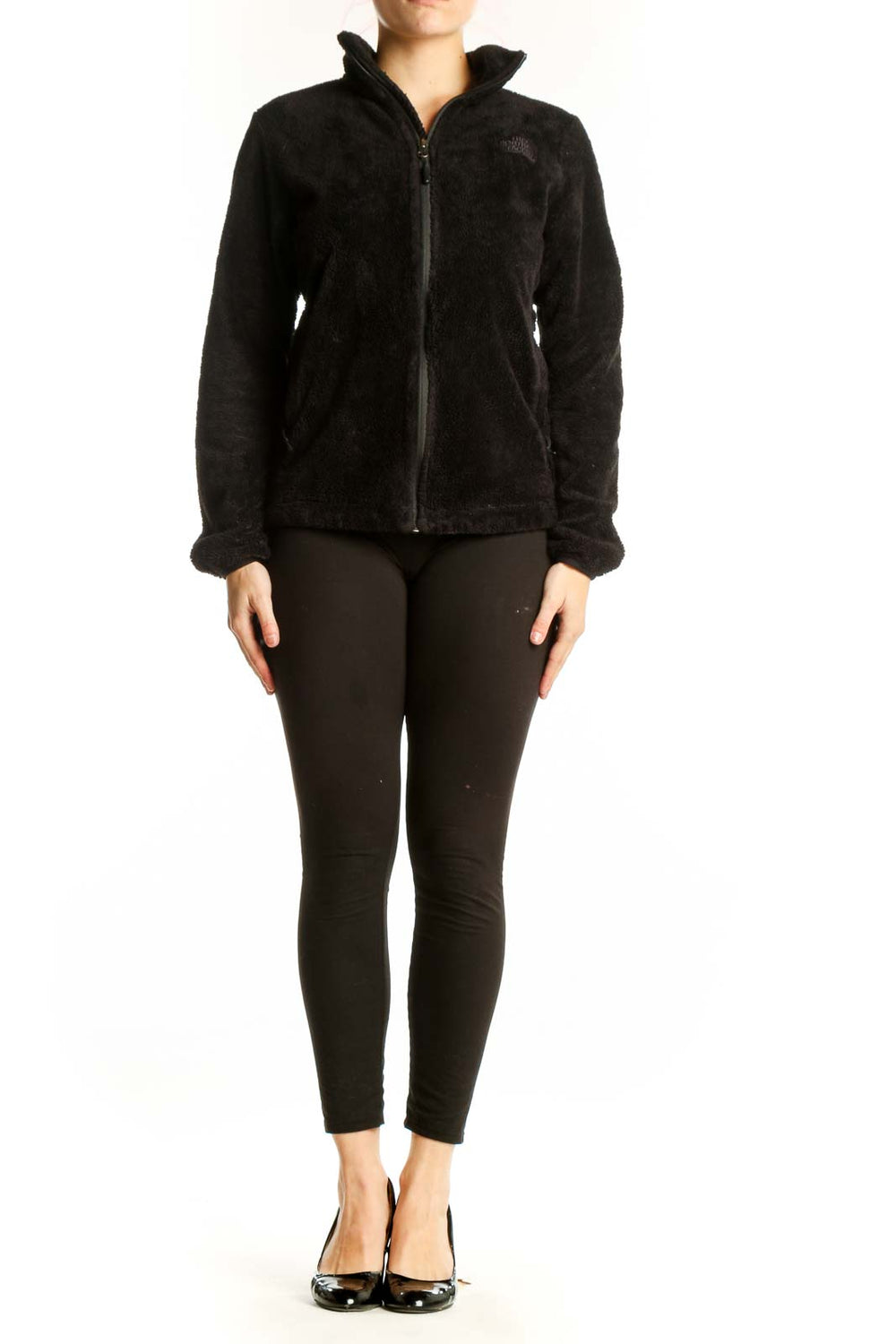 Black fleece zip-up jacket by The North Face with high collar, front view on model
