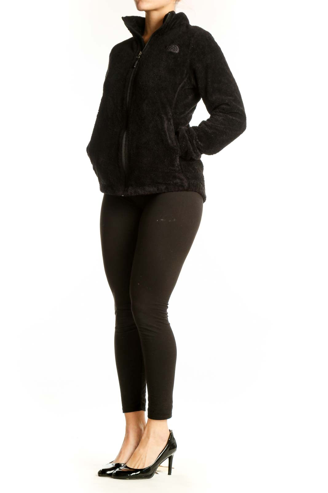 Black fleece zip-up jacket by The North Face with high collar, front view on model