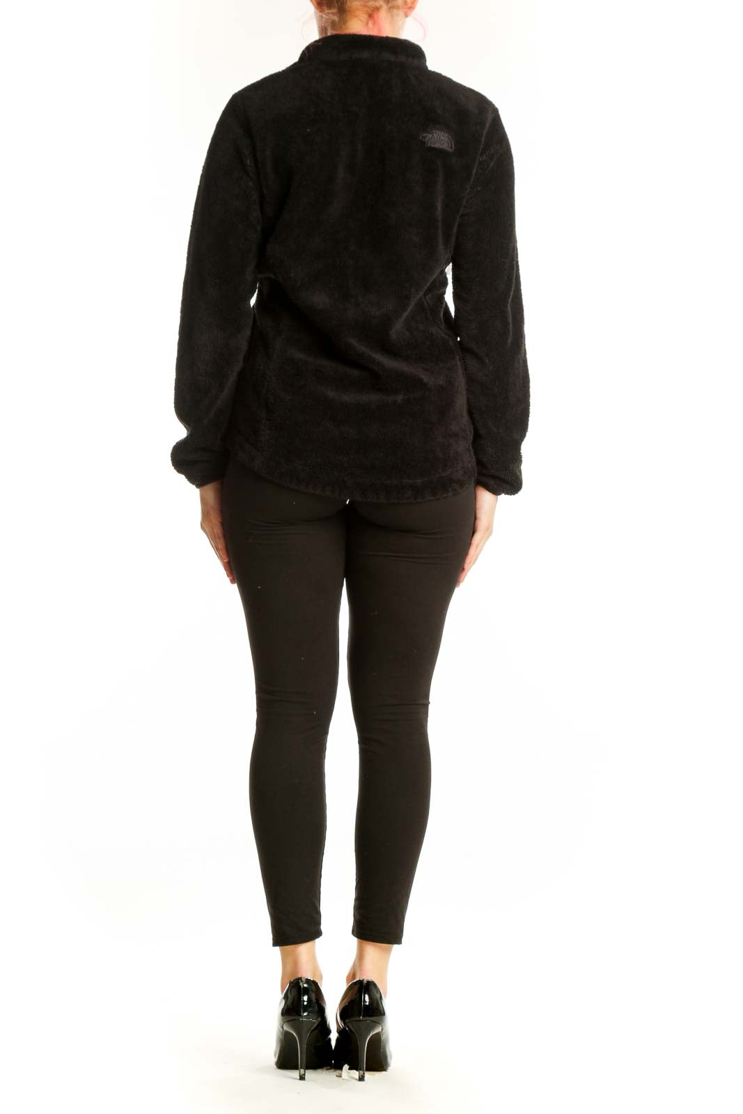 Black fleece zip-up jacket by The North Face, back view on model showing fitted silhouette