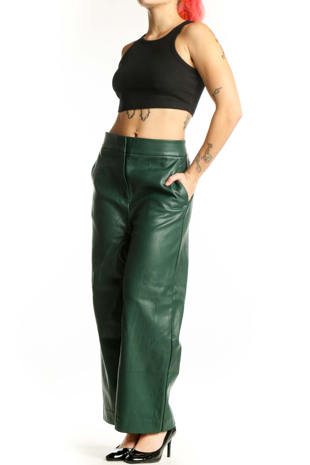 Front view of green leather wide leg pants with high waisted design and flowing silhouette