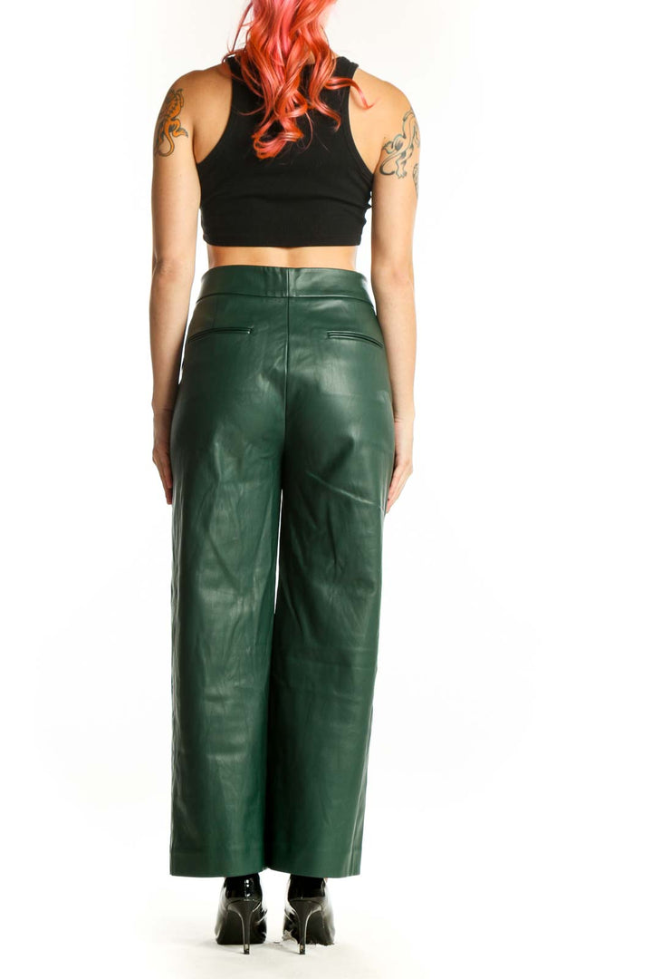 Back view of green leather wide leg pants showing elegant drape and structured fit