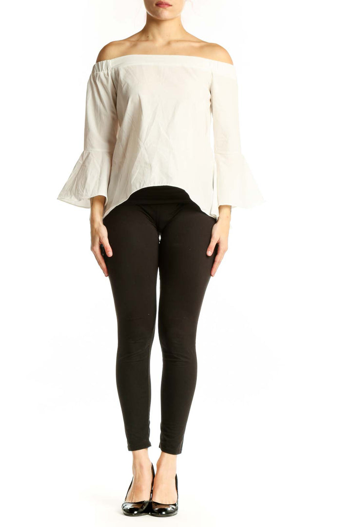 Cream off-shoulder bell sleeve cotton top with asymmetrical hem, front view on model