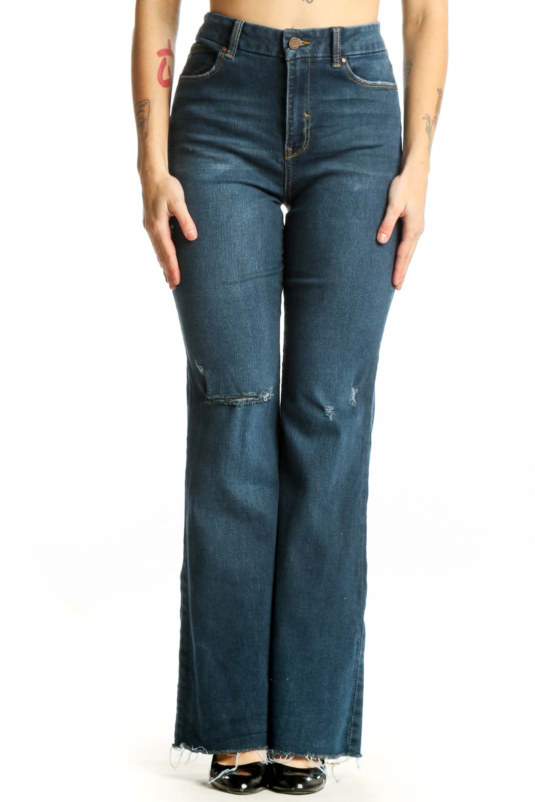 Front view of blue distressed flare jeans with high-rise fit and ripped thigh detailing