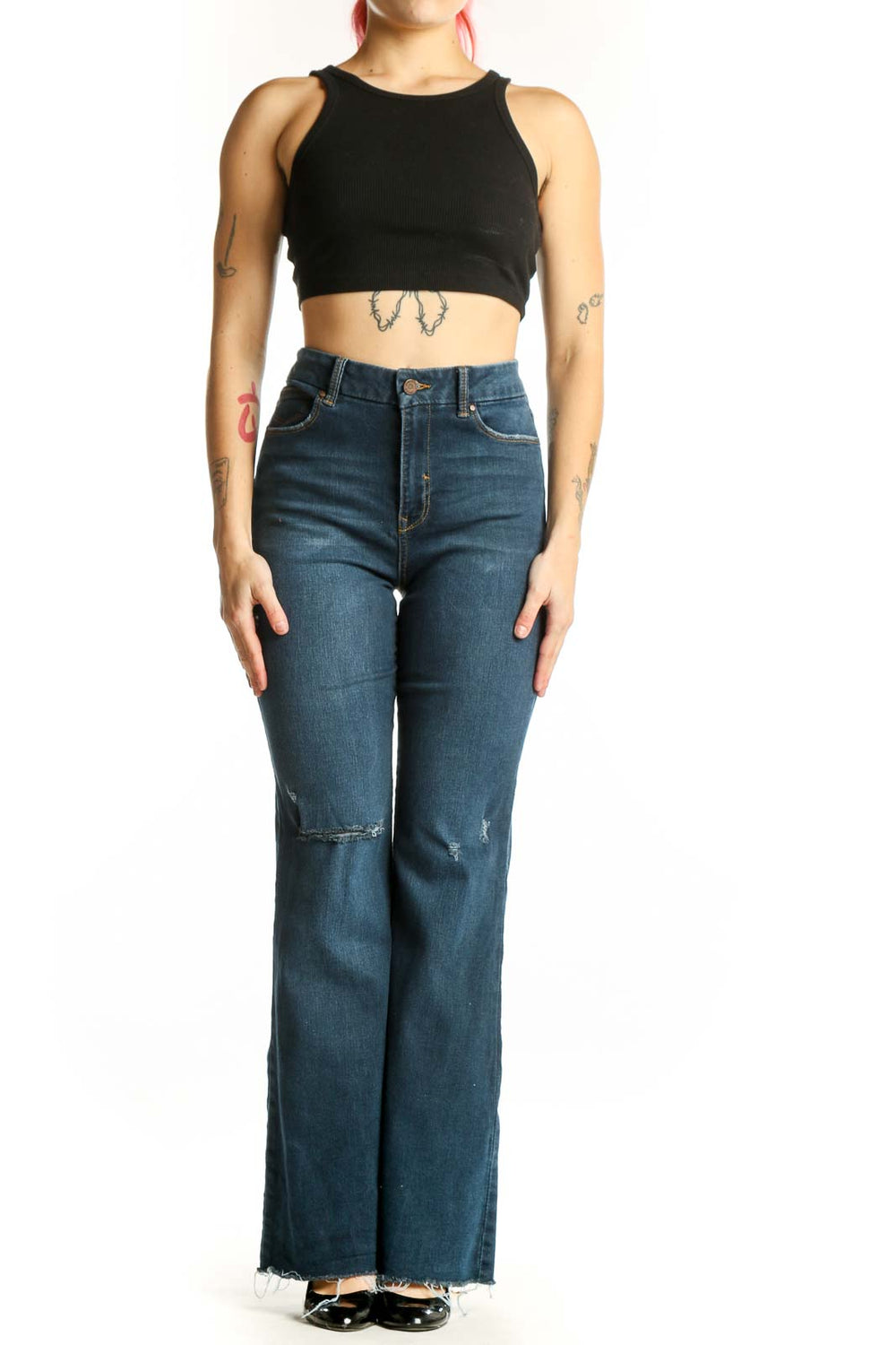 Front view of blue distressed flare jeans with high-rise fit and ripped thigh detailing
