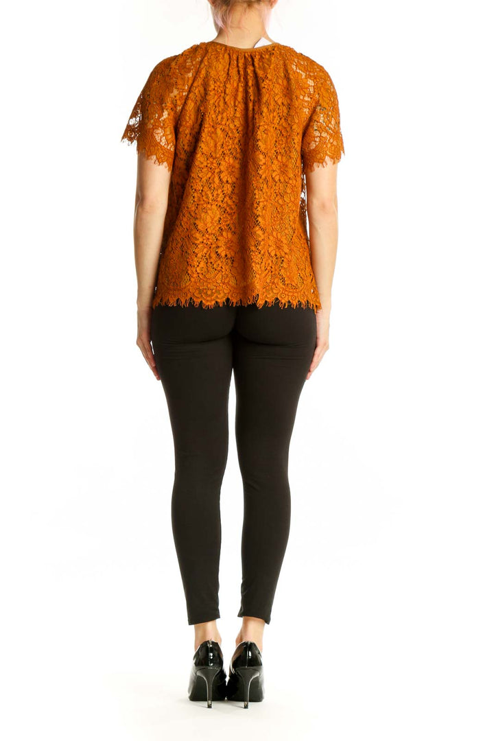 Orange lace short sleeve top with scalloped lace hem, back view