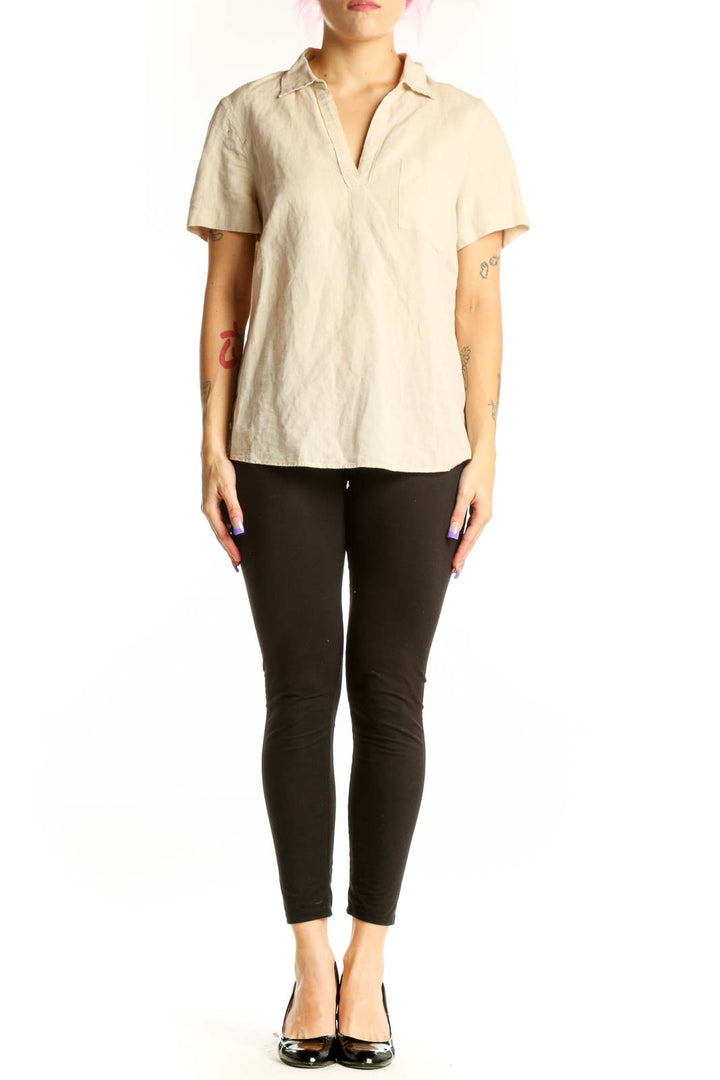 Front view of cream linen short sleeve polo top with collared neckline and chest pocket detail