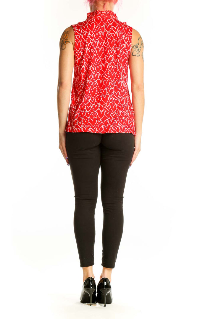 Red sleeveless top with white heart print and ruffle collar detail, back view
