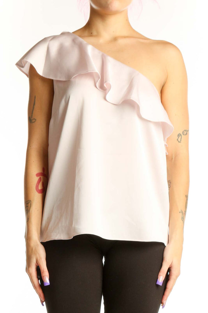 Cream one-shoulder ruffle top with cascading ruffle detail and asymmetrical neckline
