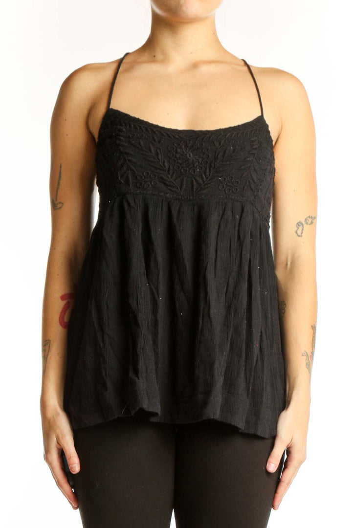 Free People black embroidered camisole tank top with empire waist and spaghetti straps, front view