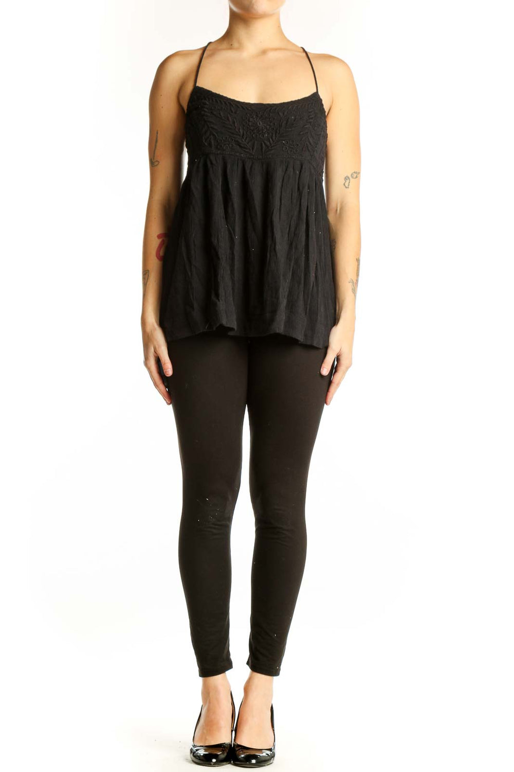 Free People black embroidered camisole tank top with empire waist and spaghetti straps, front view
