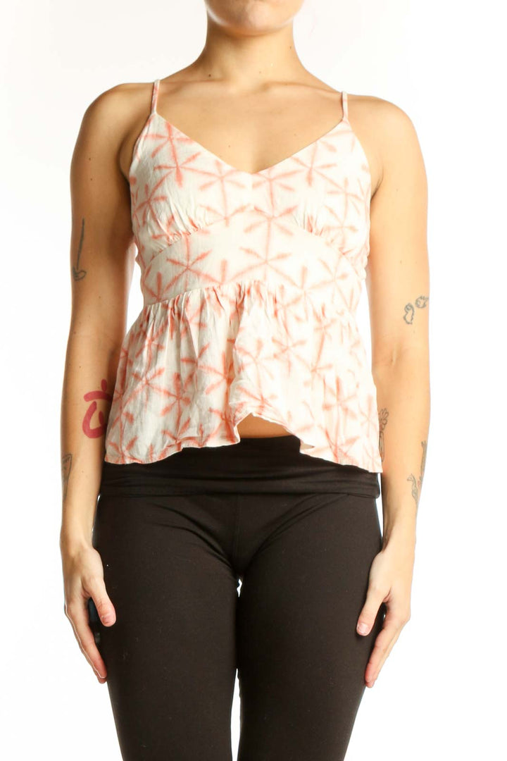 Cream and coral geometric print LOFT camisole top with V-neckline and peplum hem, front view on model
