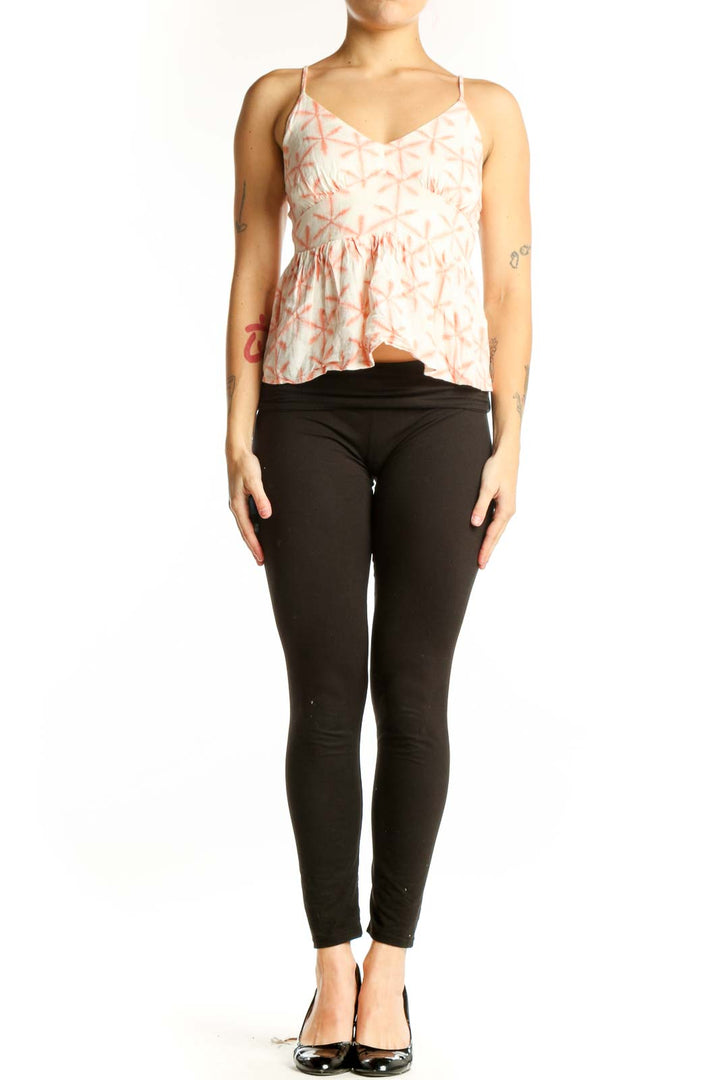 Cream and coral geometric print LOFT camisole top with V-neckline and peplum hem, front view on model