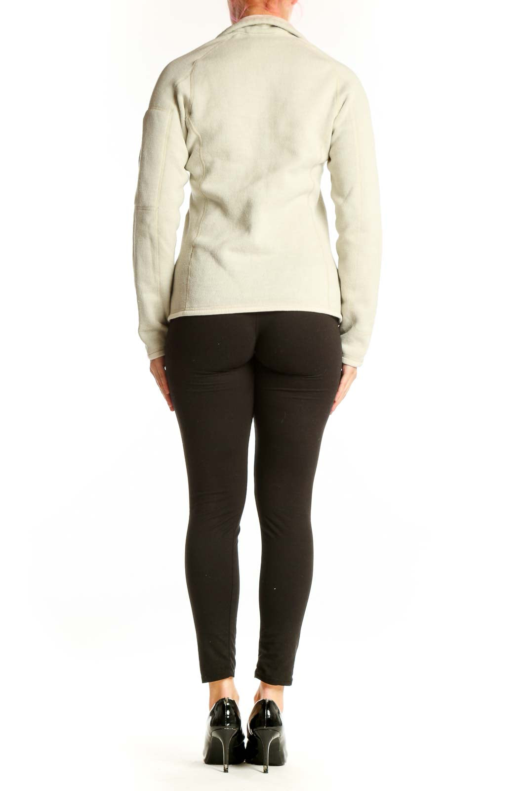 Back view of cream Patagonia fleece zip jacket with hood on woman in profile