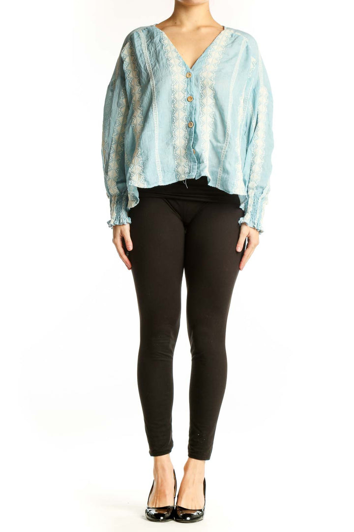 Light blue lace button-up cropped blouse with puffed sleeves and cream lace detailing, front view