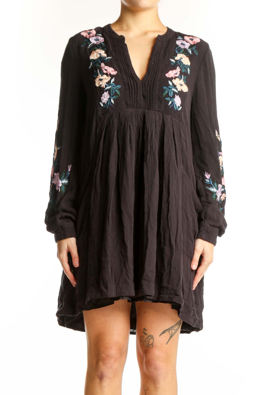 Black modal dress with floral embroidery on chest and sleeves, V-neckline with pleated detailing, flowing A-line silhouette