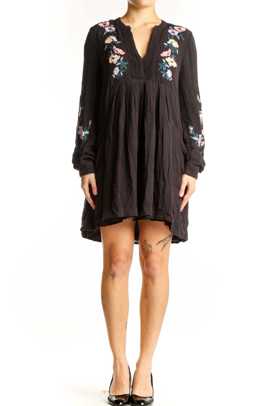Black modal dress with floral embroidery on chest and sleeves, V-neckline with pleated detailing, flowing A-line silhouette