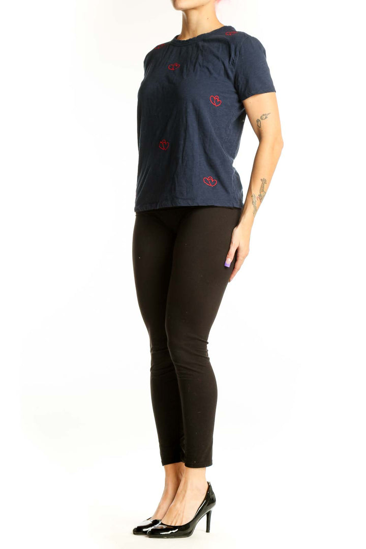Navy cotton t-shirt with red heart embroidery design, front view on model