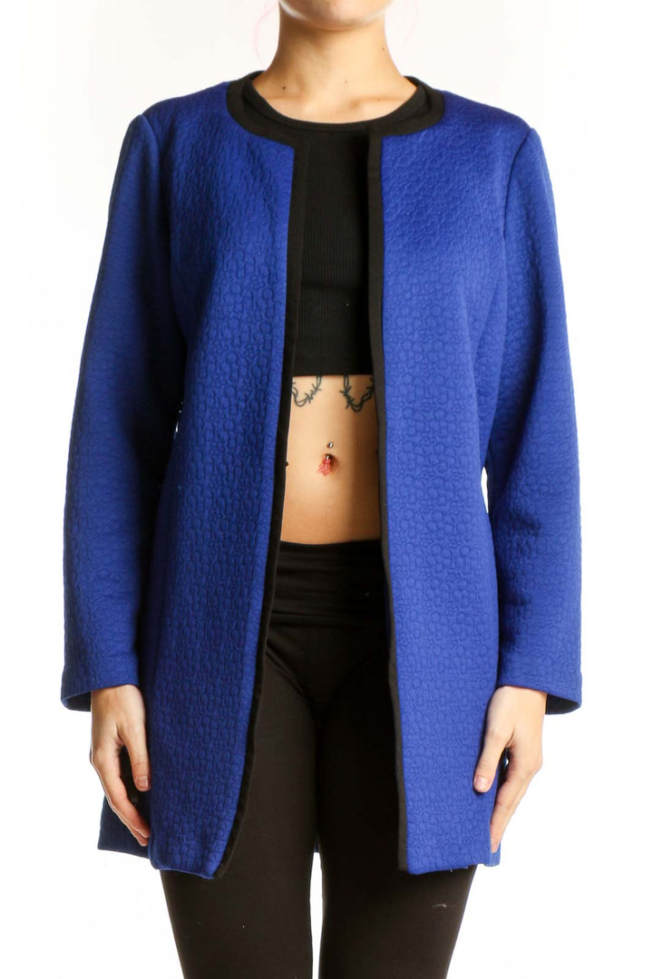 Blue open front cardigan jacket with black ribbed neckline, worn with black crop top and black pants
