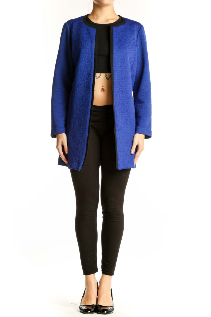 Blue open front cardigan jacket with black ribbed neckline, worn with black crop top and black pants