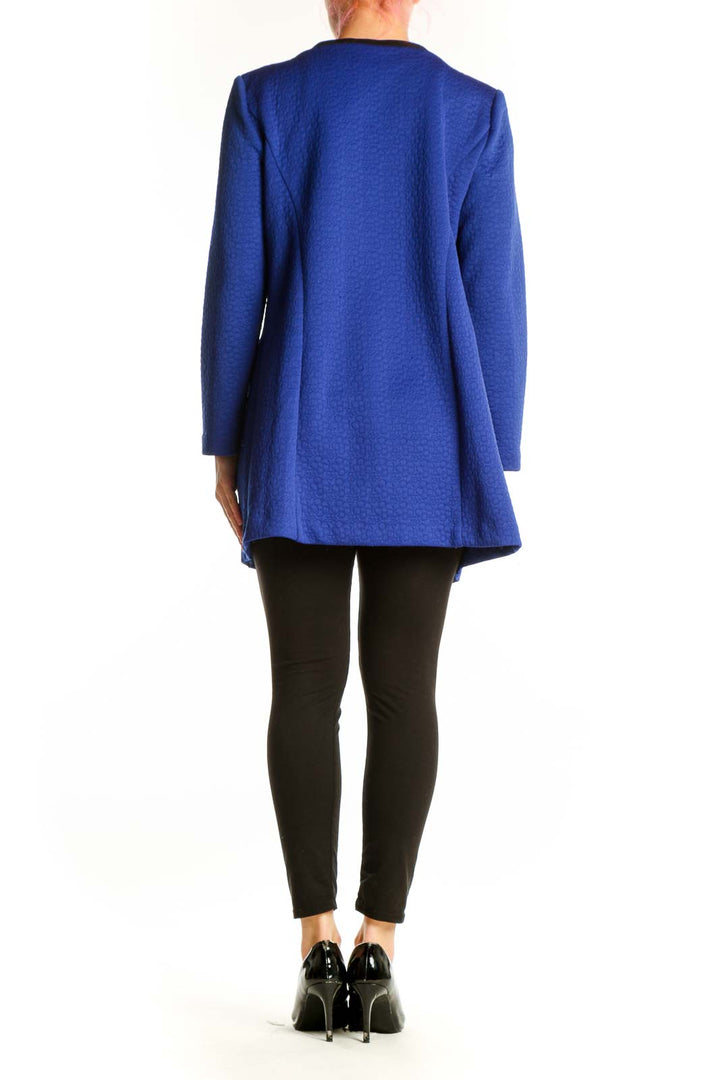 Back view of blue textured knit cardigan jacket showing relaxed fit and knee-length cut