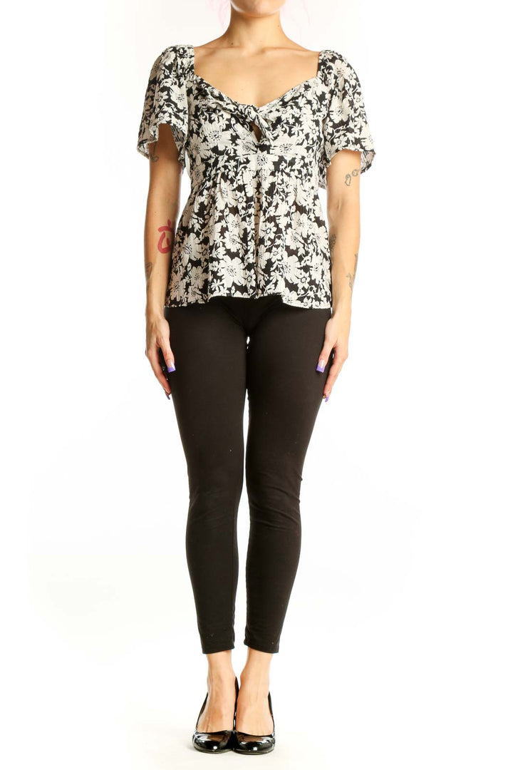 Black and white floral puff sleeve top with sweetheart neckline and gathered front detail, front view
