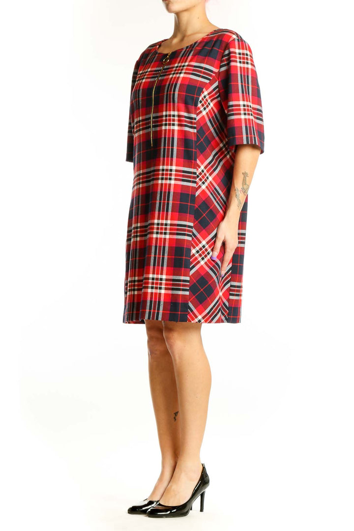 Red, navy, and white plaid shift dress with front zip closure and half-length sleeves