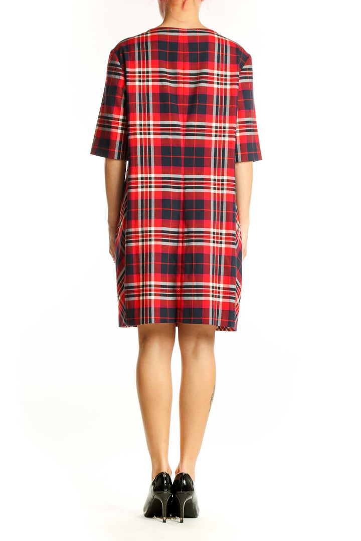 Back view of red plaid shift dress showing relaxed fit and knee-length cut
