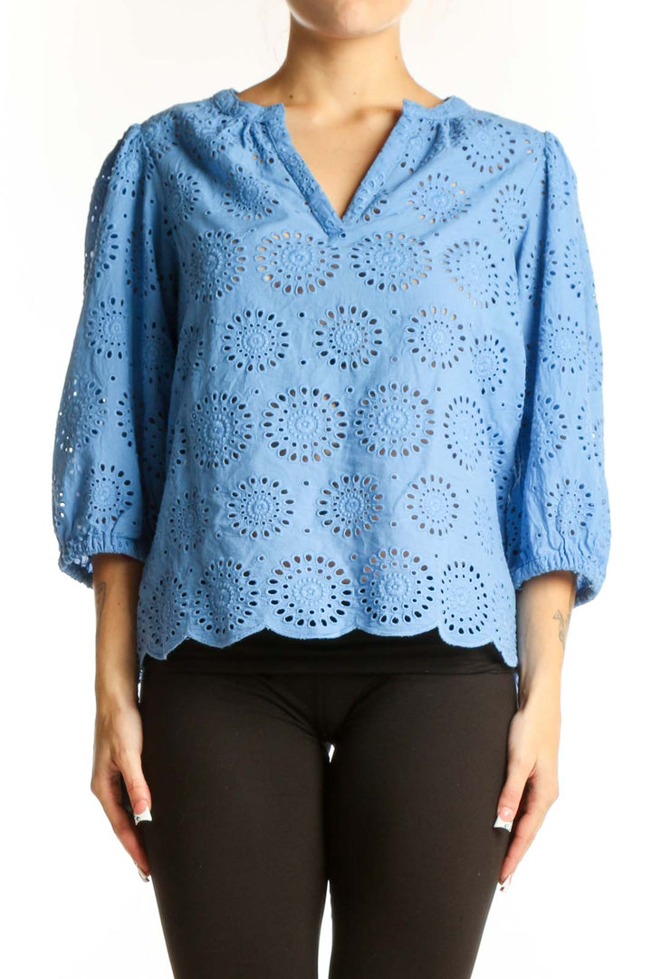 Front view of blue cotton eyelet lace blouse with V-neck and three-quarter sleeves