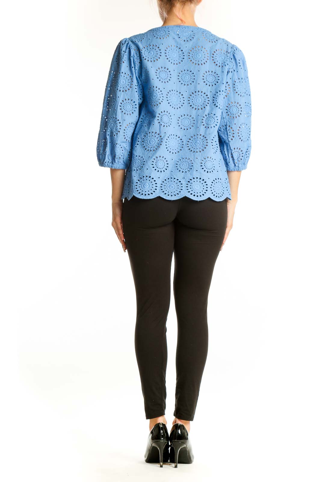 Side view of blue cotton eyelet lace blouse showing scalloped hem and relaxed fit