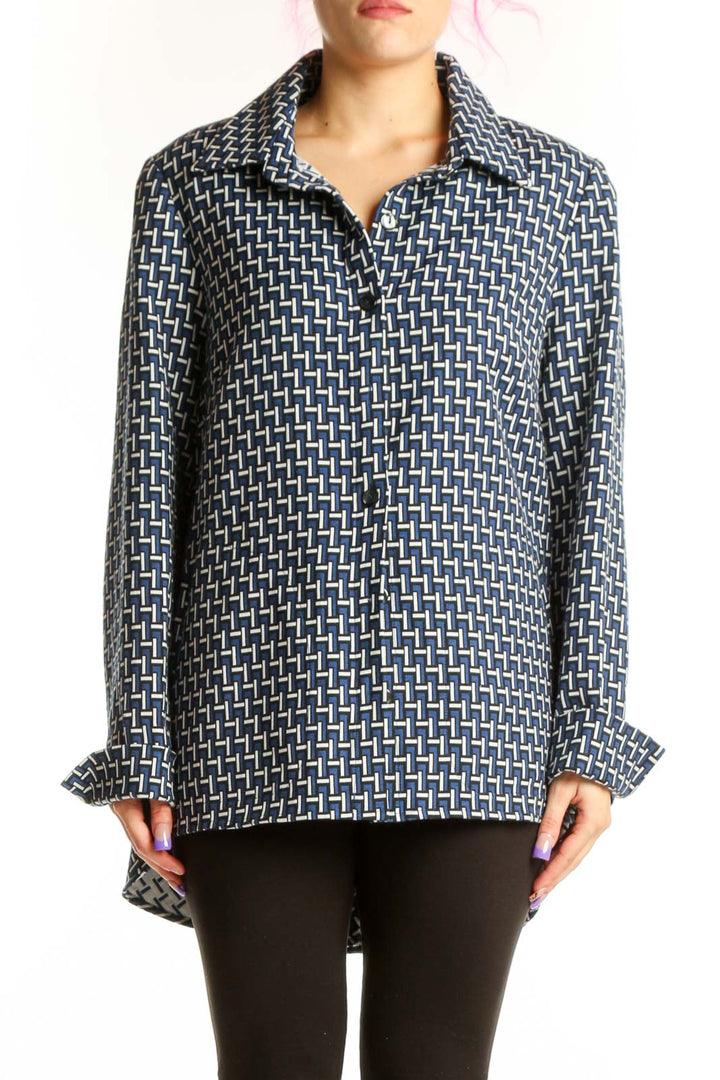 Navy geometric print button-up jacket with white pattern, long sleeves, and collared neckline worn with black pants
