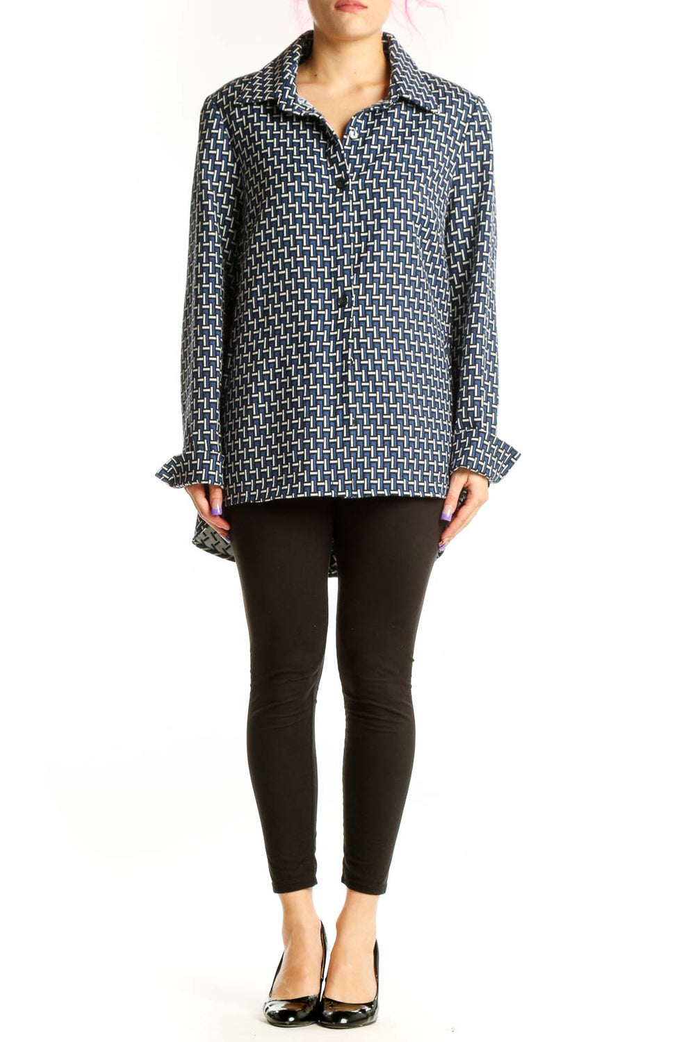 Navy geometric print button-up jacket with white pattern, long sleeves, and collared neckline worn with black pants