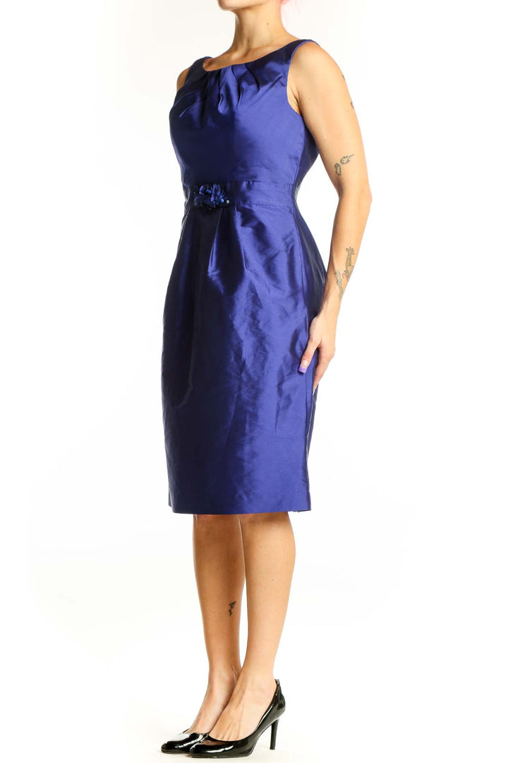 Navy blue satin cocktail dress with ruched neckline and embellished waist detail, front view