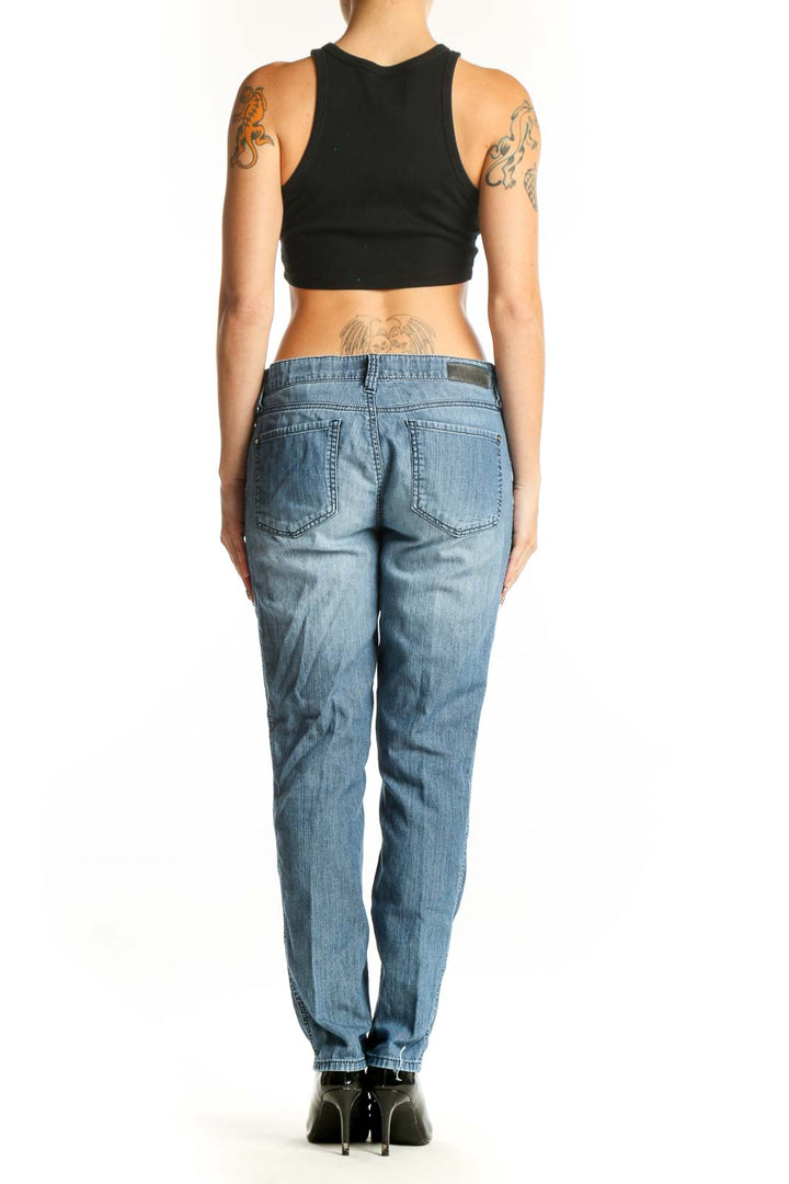 Back view of DKNY light blue straight leg jeans on model