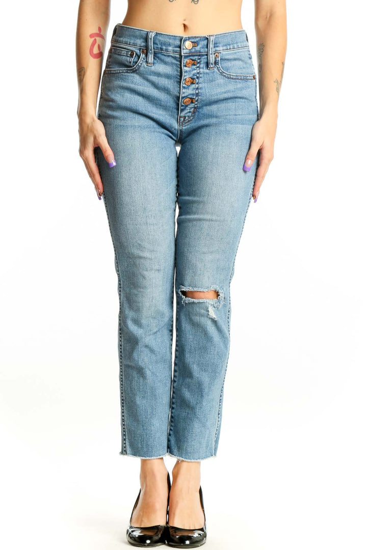 Front view of light blue J.Crew distressed cropped jeans with button-fly closure and ripped knee detail