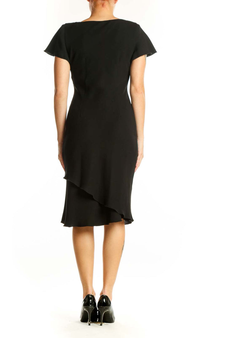 Black flutter sleeve midi dress with V-neckline and asymmetrical hemline, back view