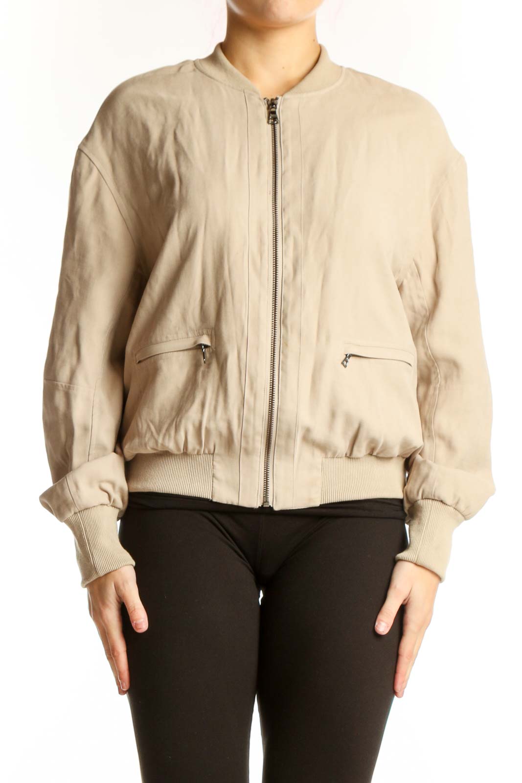 Front view of cream quilted bomber jacket with full zip closure and side pockets