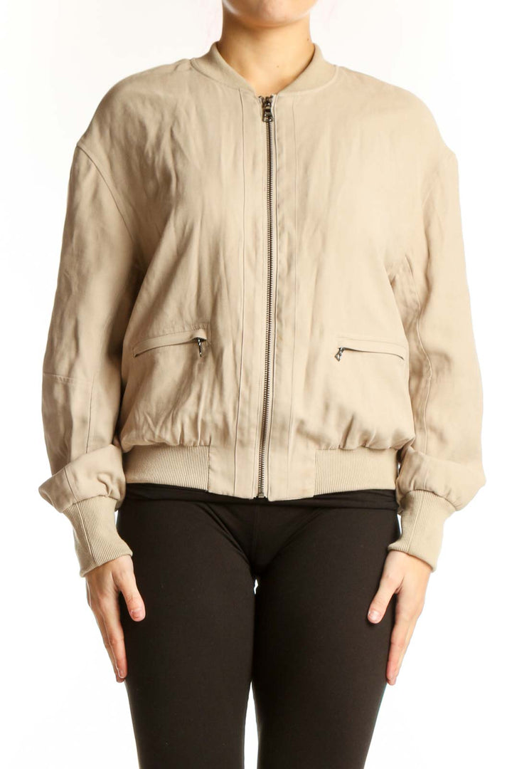 Front view of cream quilted bomber jacket with full zip closure and side pockets
