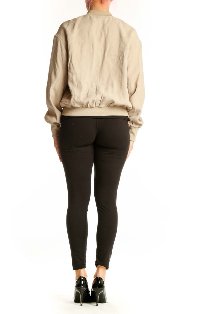 Back view of cream quilted bomber jacket showing tailored fit and ribbed hem