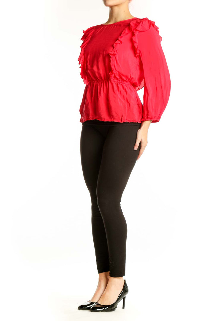 Red ruffle long sleeve viscose top with dramatic shoulder ruffles and cinched waist, front view