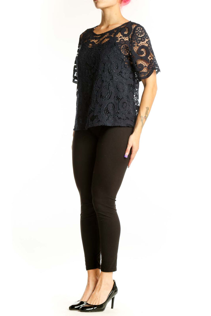Black lace short sleeve top with intricate lace overlay and flutter sleeves, front view