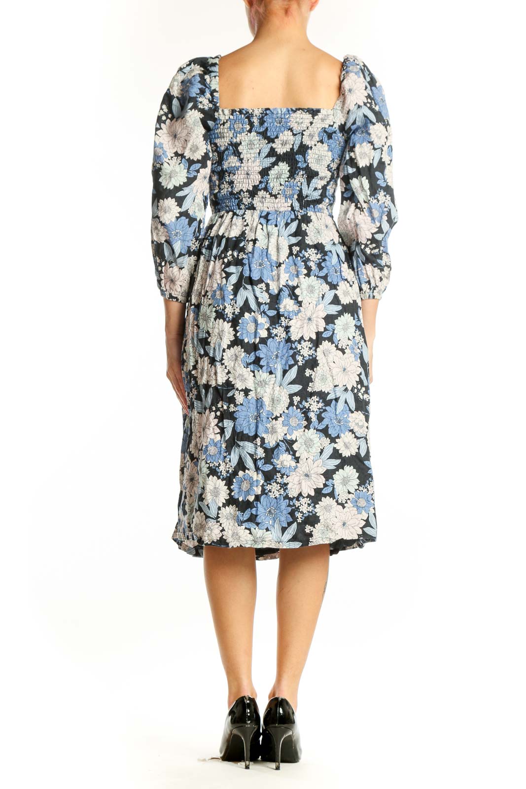 Back view of blue floral midi dress showing A-line silhouette and side slit detail