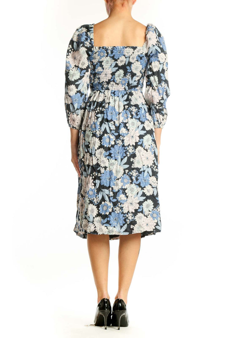 Back view of blue floral midi dress showing A-line silhouette and side slit detail