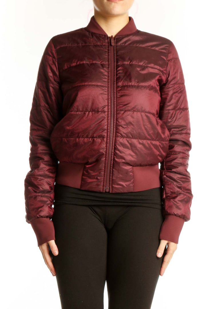 Burgundy quilted puffer bomber jacket with full-length zipper and ribbed cuffs, worn with black leggings