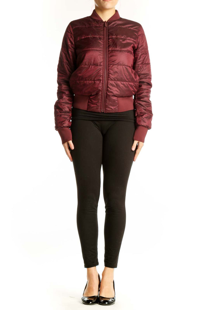 Burgundy quilted puffer bomber jacket with full-length zipper and ribbed cuffs, worn with black leggings