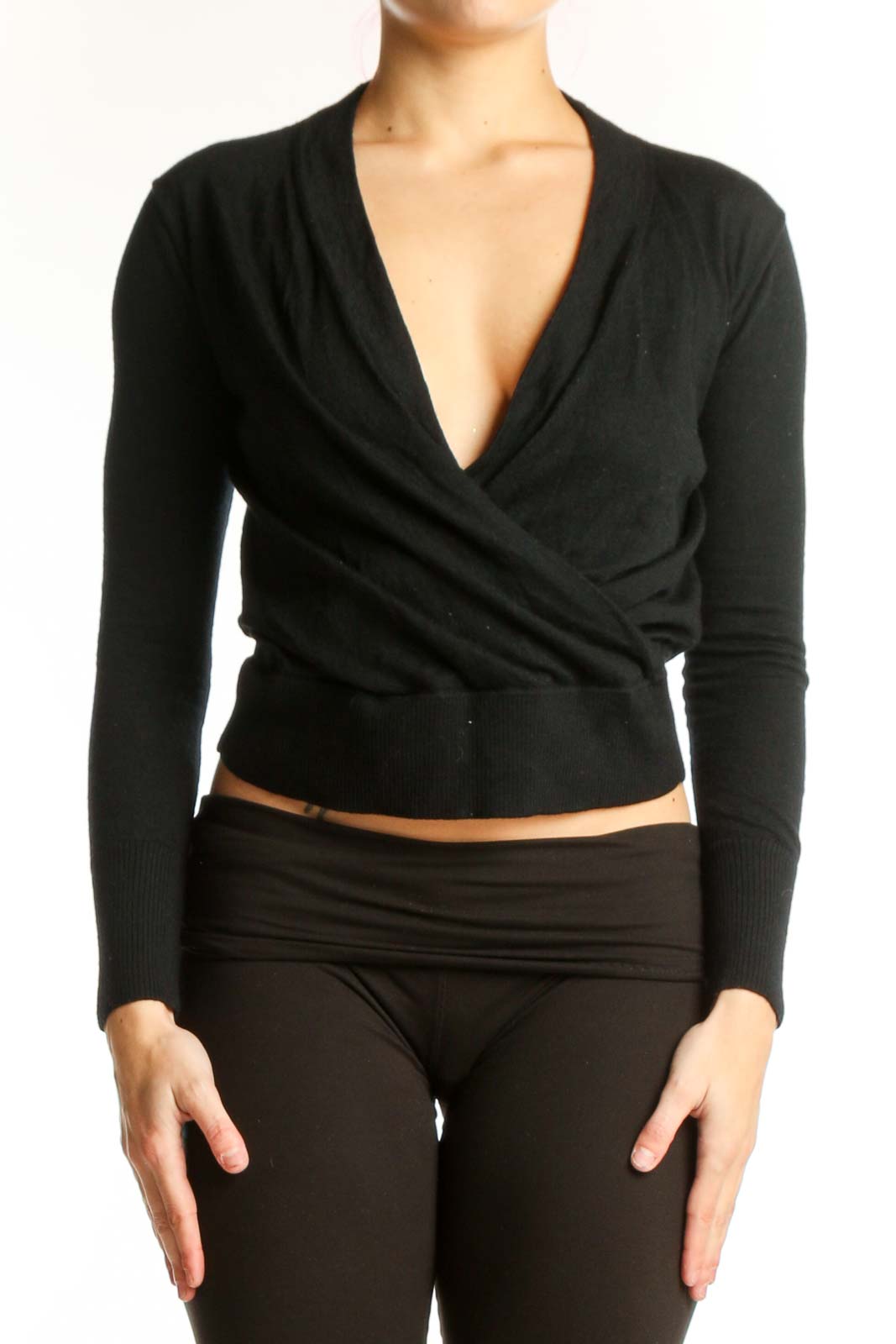 Black Merino Wool wrap crop top with V-neckline and wrap-front design, shown on model from front