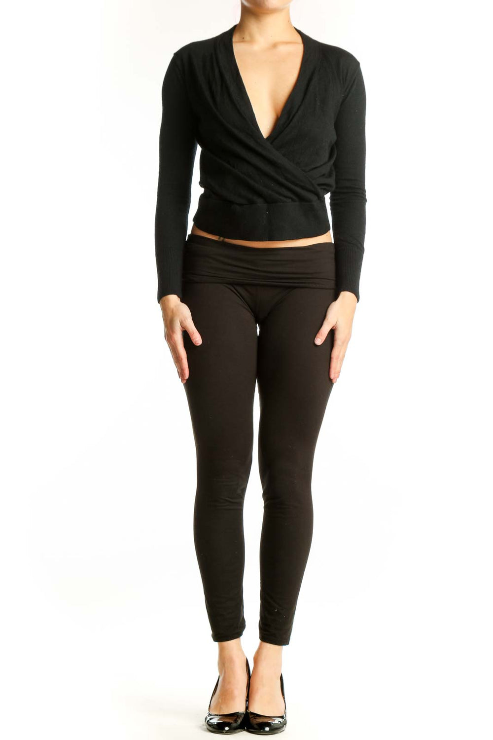 Black Merino Wool wrap crop top with V-neckline and wrap-front design, shown on model from front